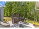 Outdoor patio area featuring grilling and bar area with a view to the lawn and trees at 2634 Yellow Pine Rd, Raleigh, NC 27616