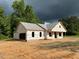 Exterior elevation showcasing a partially completed house with trees in the background at 275 Atkins Rd, Cameron, NC 28326