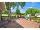 Large wooden deck with seating overlooking a beautiful backyard featuring a pool, fire pit, and green space at 2925 Redwood Rd, Durham, NC 27704