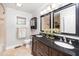 Elegant bathroom featuring double vanities with black granite countertops and updated fixtures at 2925 Redwood Rd, Durham, NC 27704
