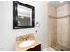 Cozy bathroom featuring a vanity, large mirror, and a shower with stone accents at 2925 Redwood Rd, Durham, NC 27704