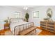 Bright bedroom with a vintage metal bed frame, hardwood floors, and modern decor at 2925 Redwood Rd, Durham, NC 27704