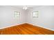 Cozy bedroom with hardwood floors, neutral walls, and ample natural light at 2925 Redwood Rd, Durham, NC 27704