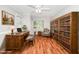Sunlit bedroom features a desk, bookshelf, and comfortable seating area at 2925 Redwood Rd, Durham, NC 27704