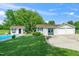 Home with a pool, garages, and a shed nestled among mature trees and green grass at 2925 Redwood Rd, Durham, NC 27704