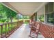Charming front porch featuring rocking chairs and a swing, perfect for relaxing and enjoying the scenery at 2925 Redwood Rd, Durham, NC 27704