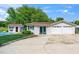 Spacious two-car garage with an adjacent pool house, nestled in a well-maintained, green landscape at 2925 Redwood Rd, Durham, NC 27704