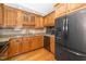 Charming kitchen with wooden cabinets, granite counters, and stainless steel refrigerator at 2925 Redwood Rd, Durham, NC 27704