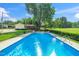 Inviting in-ground swimming pool with lounge chairs and a lush green lawn at 2925 Redwood Rd, Durham, NC 27704