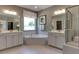 Luxurious bathroom featuring separate vanities, a soaking tub, a glass enclosed shower, and contemporary lighting at 2960 Hanging Valley Way, Wake Forest, NC 27587