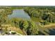 Aerial view of the community lake surrounded by mature trees and beautiful homes at 308 Minton Valley Ln, Cary, NC 27519