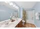 Bright bathroom featuring a double vanity, tile flooring, and tub with shower at 308 Minton Valley Ln, Cary, NC 27519