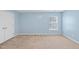This bedroom has a light blue wall and a window that brings in natural light at 308 Minton Valley Ln, Cary, NC 27519