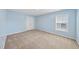 Spacious bedroom with carpeted floors, light blue walls and a window at 308 Minton Valley Ln, Cary, NC 27519