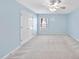 Bedroom with a ceiling fan, a window, a closet and carpeted floors and light blue walls at 308 Minton Valley Ln, Cary, NC 27519