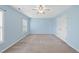 Bedroom with carpet, ceiling fan, window and a closet painted in a light blue at 308 Minton Valley Ln, Cary, NC 27519