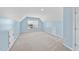 Large bonus room with neutral carpet, and blue accent walls offering ample space for customization at 308 Minton Valley Ln, Cary, NC 27519