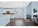 Open concept dining room with hardwood floors and an elegant chandelier at 308 Minton Valley Ln, Cary, NC 27519