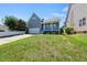View of the back of the home with a 2 car garage and a lovely blue porch at 308 Minton Valley Ln, Cary, NC 27519