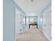Hallway leading to office space with desk and white doors, painted in light blue with carpeted flooring at 308 Minton Valley Ln, Cary, NC 27519