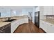 Bright kitchen features stainless steel appliances, white cabinetry, and wood-look flooring at 308 Minton Valley Ln, Cary, NC 27519