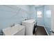 Bright laundry room includes a sink, modern washer and dryer, and wood-look flooring at 308 Minton Valley Ln, Cary, NC 27519