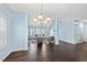 Spacious living room with hardwood floors, many windows, and light blue walls at 308 Minton Valley Ln, Cary, NC 27519