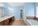 Well-lit main bathroom includes a soaking tub, dual vanity, and walk-in closet access at 308 Minton Valley Ln, Cary, NC 27519