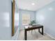Light blue office space featuring carpet, desk, modern art, and natural light from the window at 308 Minton Valley Ln, Cary, NC 27519