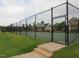 Community tennis court with well-maintained green surface surrounded by a secure fence at 308 Minton Valley Ln, Cary, NC 27519