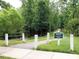 Entrance to Carpenter Village Trail with a well-maintained walking path and lush greenery at 308 Minton Valley Ln, Cary, NC 27519