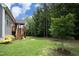 Landscaped backyard featuring lush green grass and views of the back deck at 309 Hines Point Dr, Rolesville, NC 27571