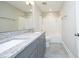 Elegant bathroom featuring a double vanity with granite counters and a tile surround tub and shower at 309 Hines Point Dr, Rolesville, NC 27571
