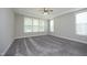 An empty bedroom offering plush carpeting, neutral walls, recessed lights, and multiple windows for ample natural light at 309 Hines Point Dr, Rolesville, NC 27571