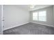 Bright bedroom with plush carpet, a ceiling fan and natural light from the sunny window at 309 Hines Point Dr, Rolesville, NC 27571