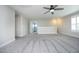 Large bonus room featuring plush carpet, a ceiling fan, and bright, natural light from large windows at 309 Hines Point Dr, Rolesville, NC 27571