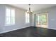 Bright dining area with hardwood floors, modern lighting, and sliding door access to an outdoor deck at 309 Hines Point Dr, Rolesville, NC 27571