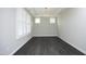 Bright, open dining room featuring dark wood floors, a modern chandelier, and ample natural light at 309 Hines Point Dr, Rolesville, NC 27571