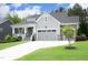 Beautiful home with a two-car garage, stone accents, well-manicured lawn, and a welcoming front porch at 309 Hines Point Dr, Rolesville, NC 27571