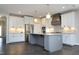 Modern kitchen featuring stainless steel appliances, granite countertops, white cabinets, and an island at 309 Hines Point Dr, Rolesville, NC 27571