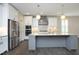 Bright kitchen with white cabinets, stainless steel appliances, and gray island at 309 Hines Point Dr, Rolesville, NC 27571