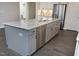 Kitchen island with stainless steel appliances and granite countertops at 309 Hines Point Dr, Rolesville, NC 27571