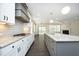 Open kitchen view with granite countertops, stainless appliances, and flow into living area at 309 Hines Point Dr, Rolesville, NC 27571
