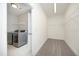 A laundry room featuring modern, stainless steel washer and dryer units, as well as shelving and neutral walls at 309 Hines Point Dr, Rolesville, NC 27571