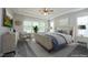 A staged main bedroom featuring a ceiling fan, neutral walls, soft carpet, and plenty of natural light at 309 Hines Point Dr, Rolesville, NC 27571