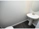 Compact powder room featuring a pedestal sink and hardwood floors at 309 Hines Point Dr, Rolesville, NC 27571