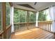 Cozy screened porch with wooden floors, balusters, and wooded views through the screen windows at 309 Hines Point Dr, Rolesville, NC 27571