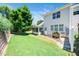 Backyard with green lawn, mature tree, and screened-in porch area at 3129 Elm Tree Ln, Raleigh, NC 27614