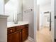 Bathroom with wood vanity and a view to a shower and water closet at 3129 Elm Tree Ln, Raleigh, NC 27614
