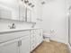 Clean bathroom featuring double vanity, modern fixtures, and a shower at 3129 Elm Tree Ln, Raleigh, NC 27614